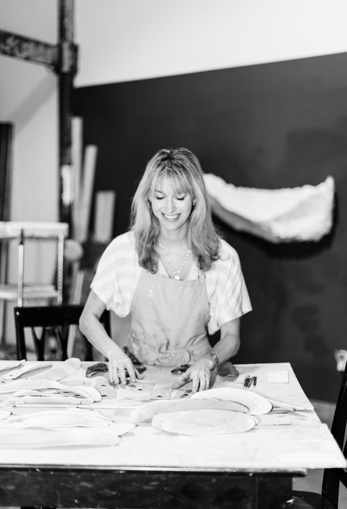 Portrait of Carlie Porter smiling creating one of her masterpieces